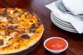 Savor the scrumptious flavor of a pizza, served on a table that adds to the visual appeal of the dish, making it even more