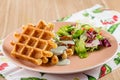 Savory Belgian waffles with cheese sauce and salad