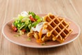 Savory Belgian waffles with egg poached, bacon and salad