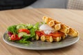 Savory Belgian waffles with egg poached, salmon and salad. eggs