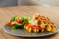 Savory Belgian waffles with egg poached, salmon and salad. eggs