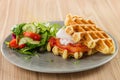 Savory Belgian waffles with egg poached, salmon and salad. eggs