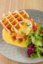 Savory Belgian waffles with mustard sauce and salad