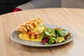 Savory Belgian waffles with mustard sauce and salad