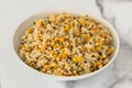 A savory blend of pearled couscous, orzo, baby garbanzo beans, and red quinoa, cooked, and served in a bowl