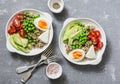 Savory breakfast grain bowl. Balanced buddha bowl with quinoa, egg, avocado, tomato, green pea. Healthy diet food concept. Top vi Royalty Free Stock Photo