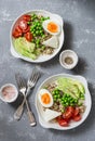 Savory breakfast grain bowl. Balanced buddha bowl with quinoa, egg, avocado, tomato, green pea. Healthy diet food concept. Top vi