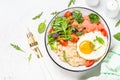 Savory breakfast with oatmeal, salmon and salad.