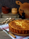 Savory cabbage pie with cheese and eggs on a wooden background. Homemade quiche.