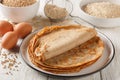 Savory crepes Buckwheat Galettes closeup on a plate with ingredients flour, cereal and eggs closeup on the wooden table.