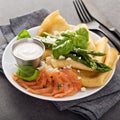 Savory crepes with salmon, sour cream and asparagus