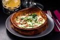 Savory dutch baby pancake with egg, bacon, traditional Dutch breakfast