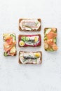 Savory fish smorrebrod, set of five traditional Danish sandwiches. Black rye bread with anchovy, beetroot, radish, eggs, salmon,