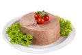 Savory meat pate served on a plate with vegetables