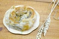 Savory meat pie with seeds on a wooden table