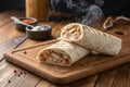 Savory Meat Wrap on Wooden Table Close-Up - generated by ai Royalty Free Stock Photo