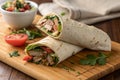 Savory Meat Wrap on Wooden Table Close-Up - generated by ai Royalty Free Stock Photo