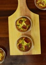 Savory mini quiches tarts on a wooden board. Baked homemade flaky dough pies. Ready for eat. Copy space Royalty Free Stock Photo