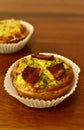 Savory mini quiches tarts on a wooden board. Baked homemade flaky dough pies. Ready for eat. Copy space Royalty Free Stock Photo