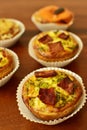 Savory mini quiches tarts on a wooden board. Baked homemade flaky dough pies. Ready for eat. Copy space Royalty Free Stock Photo