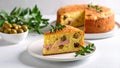 Savory olive and ham cake slice on plate with whole cake and olives in bowl Royalty Free Stock Photo