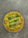 savory pie with courgettes and basil on a round plate, italian plate