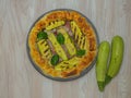 savory pie with courgettes and basil on a round plate, italian plate