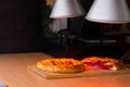 Savory pies keeping warm under heat lamps