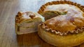 Savory 9 inch celebration Pork Pie slice Delights on Rustic Wooden Table side view