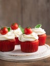 Savory salted tomato cherry cupcakes snacks with cream cheese frosting on on wooden background. Selective focus. Appetizer, Royalty Free Stock Photo
