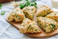 Savory scones with feta and mozarella and green herbs on a woode
