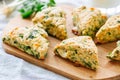 Savory scones with feta and mozarella and green herbs on a woode Royalty Free Stock Photo