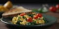 Savory spinach scrambled eggs on a dark plate