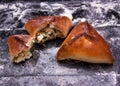 Savory stuffed patties on black baking tray. Country house style. Authentically