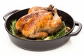 Savory and succulent whole roast chicken with crispy skin, beautifully cooked in a sizzling pan