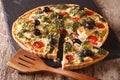 savory tart with chicken, broccoli, tomatoes and olives close-up. horizontal