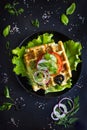 Savory waffle with cheese, ham, olives and herbs, served with fr Royalty Free Stock Photo