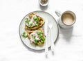 Savory zucchini waffles with tuna, cream cheese pate and coffee on a light background, top view. Delicious healthy breakfast,