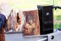 Saw cutting wood for winter. A man cutting firewood for the winter using a modern machine lumber saw. Royalty Free Stock Photo