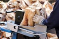 Saw cutting wood for winter. A man cutting firewood for the winter using a modern machine lumber saw. Royalty Free Stock Photo