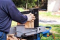 Saw cutting wood for winter. A man cutting firewood for the winter using a modern machine lumber saw. Royalty Free Stock Photo