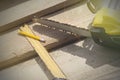 Saw, pencil and a square line on the rafters. Construction of wooden houses and roofs Royalty Free Stock Photo