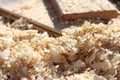 Sawdust and light wood shavings close-up the carpentry workshop after sawn timber processing Royalty Free Stock Photo