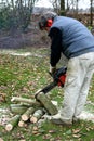 Sawing firewood with a chainsaw