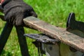 Sawing old boards with a circular saw. The process of sawing wood for processing. close the circular saw for cutting wood Royalty Free Stock Photo