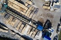 Sawmill aerial view chopped tree wood logs stacks in a row with machinery