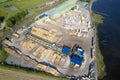 Sawmill aerial view chopped tree wood logs stacks in a row with machinery