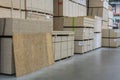 Sawn timber. Drywall, dvp, chipboard, Shelf with structural materials on the shelves in the construction warehouse. Delivery conce