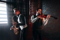 Sax man and fiddler duet playing classical melody Royalty Free Stock Photo