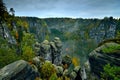 Saxon switzerland rathen bastei - rathener kessel - sandstone rock formations autumn forest clouds mist moody Royalty Free Stock Photo